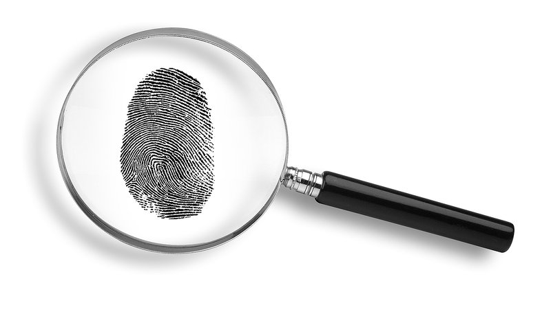 Magnifying glass viewing a thumbprint