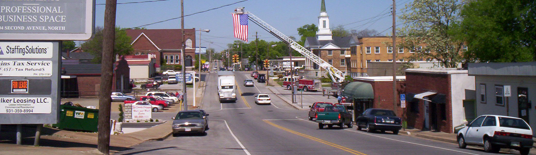 City street with fire truck ladder extended over it